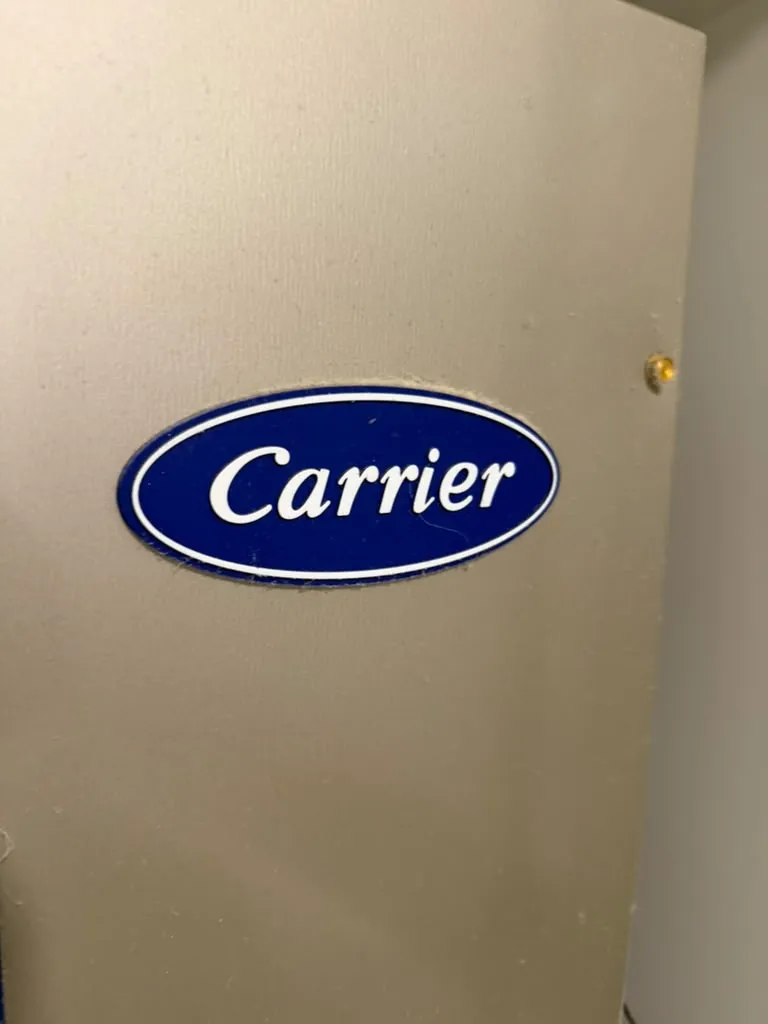 Carrier badge on the blower door of a furnace cabinet