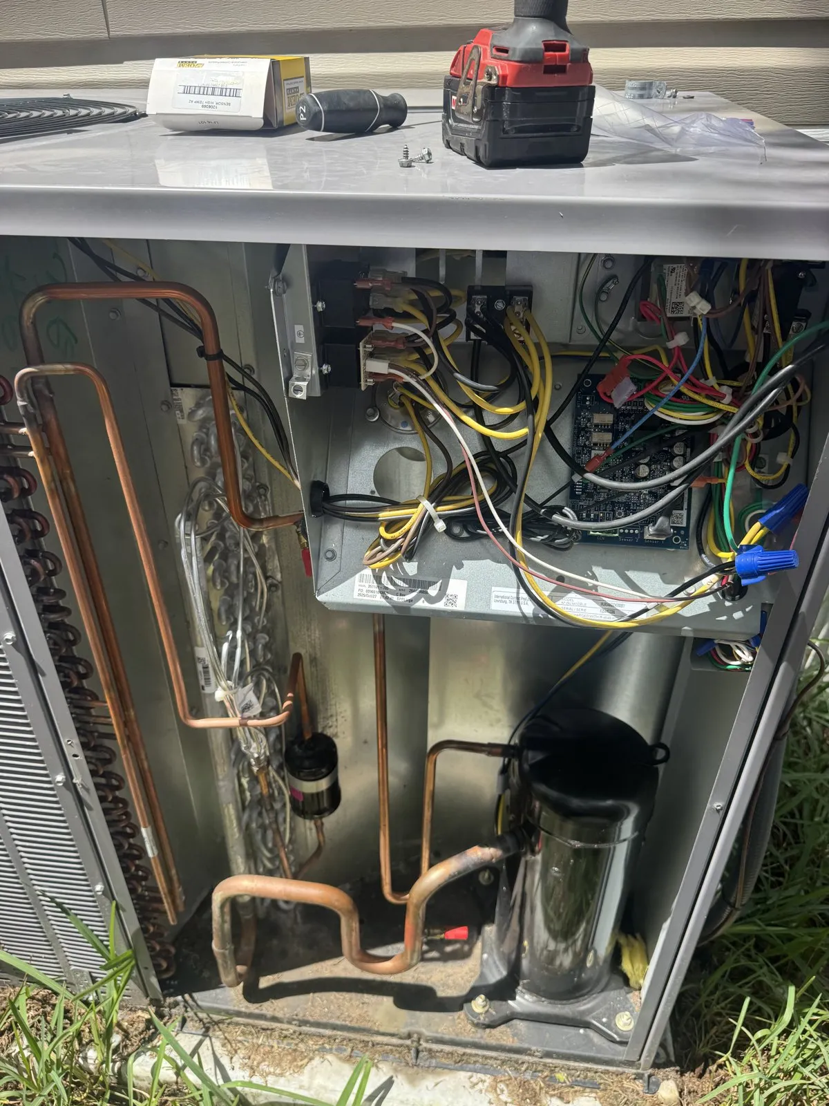 Open outdoor AC unit showing the copper line set and compressor, north Pasco County FL