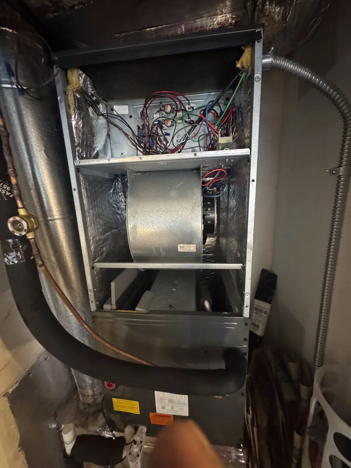 Open air handler showing the blower wheel and insulated copper lines during inspection, Florida Ave, Seminole Heights, Tampa FL 33603