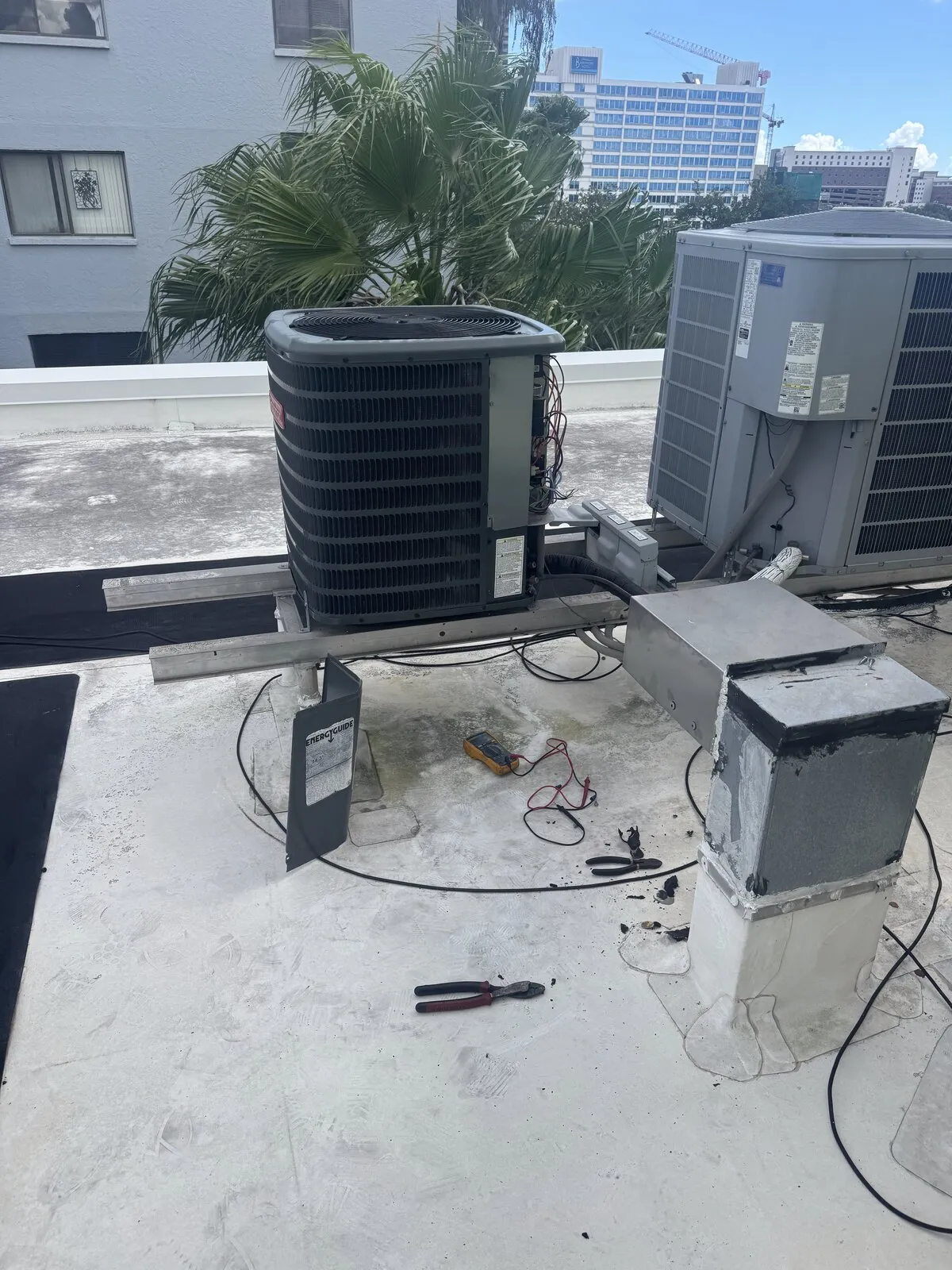 Two outdoor AC units on a commercial rooftop during a changeout, Florida Ave area, Tampa FL