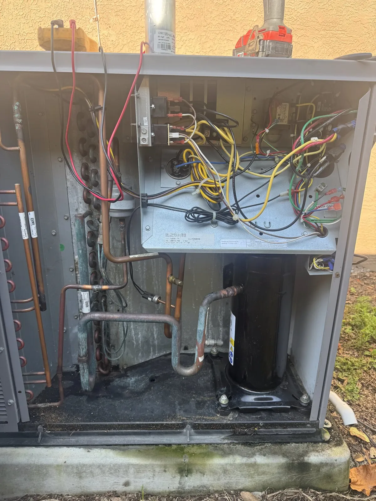 Outdoor AC unit with the service panel open for capacitor and contactor testing, Hillsborough Ave, Tampa FL 33614