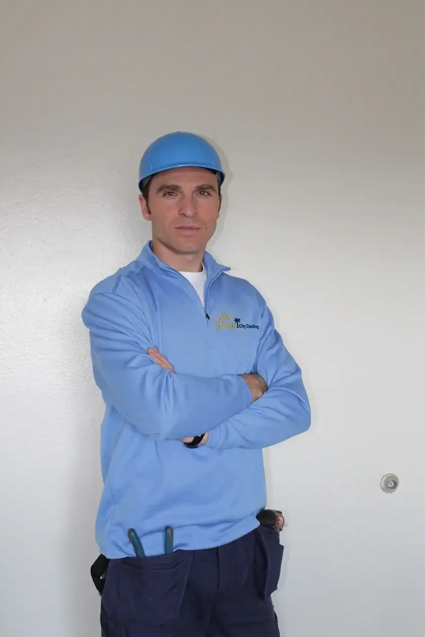 Sunny City Cooling technician, arms crossed, in branded workwear