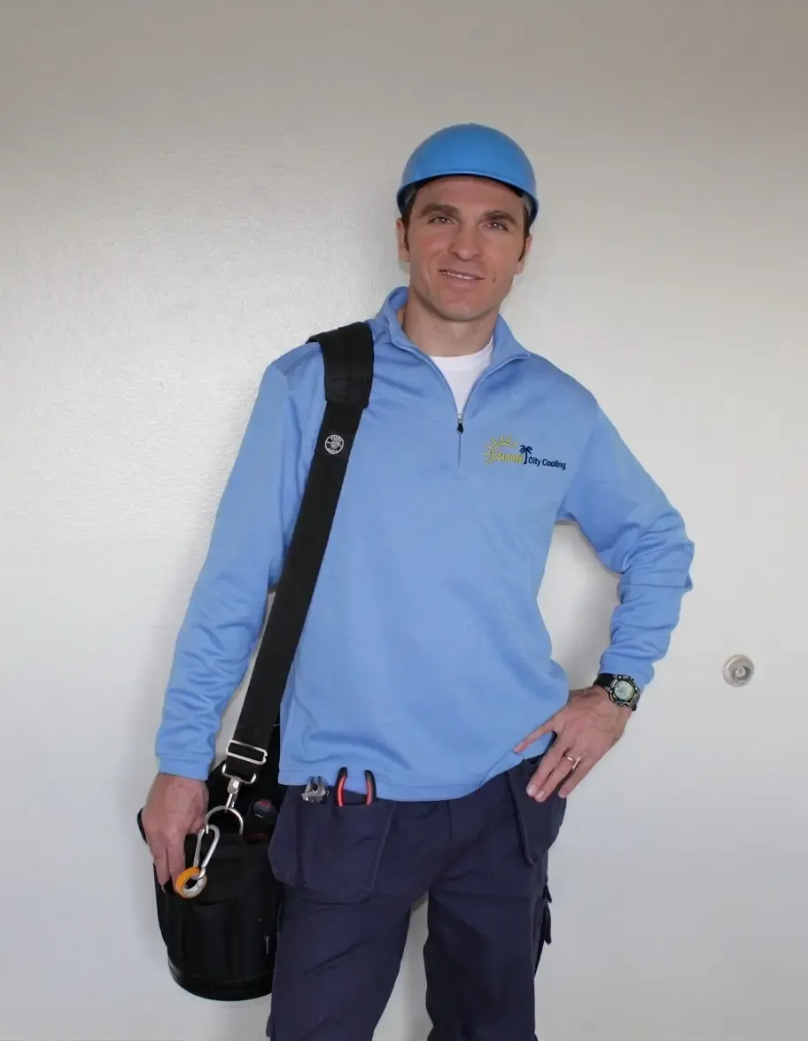 Sunny City Cooling technician in branded workwear with a tool bag
