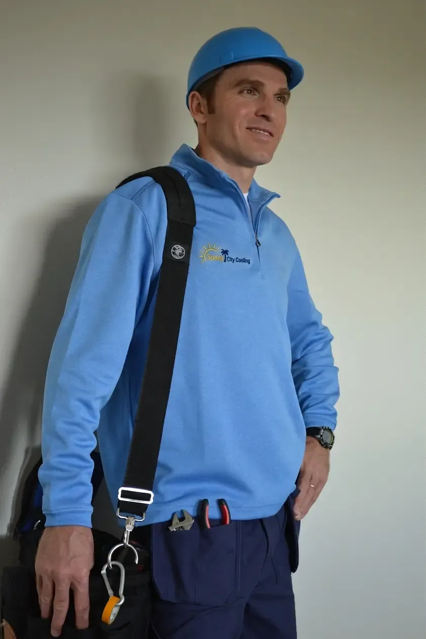 Sunny City Cooling technician with a full tool bag, ready for a service visit